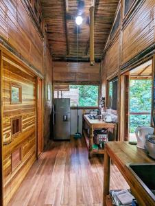 a kitchen with wooden walls and a wooden floor at Yogachal Vista Mar Bamboo House in the Jungle in Ojochal