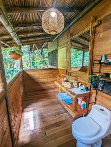 a bathroom with a toilet and a sink at Yogachal Vista Mar Bamboo House in the Jungle in Ojochal