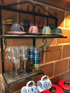 a shelf with wine glasses and other items on it at Casa de Praia - meu lugar em Iriri in Anchieta