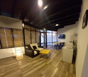 a living room with a couch and a table at Departamento con piscina en Vistalba in Vistalba