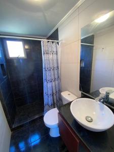 a bathroom with a sink and a toilet and a shower at Casa Josefa in Pelluhue