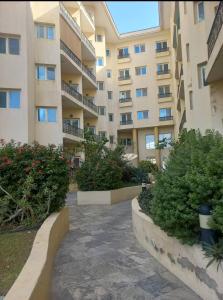 a large apartment building with bushes in front of it at Ruby Star Hostel 21 Dubai in Dubai