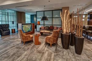 a lobby with chairs and a living room at Courtyard by Marriott Dulles Airport Herndon in Herndon