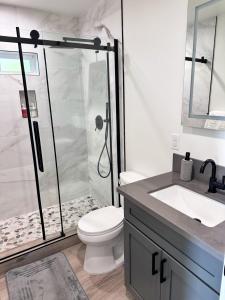 a bathroom with a shower with a toilet and a sink at Gorgeous house in Los Angeles in Los Angeles