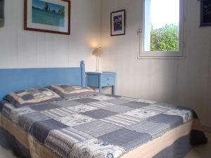 a bedroom with a bed and a nightstand and a window at Maison Le Palais, 4 pièces, 6 personnes - FR-1-418-234 in Le Palais