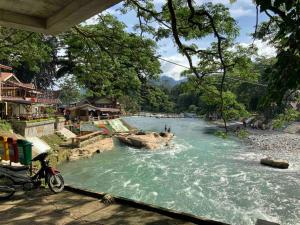 a view of a river with people swimming in it at Villa di Bukit Lawang: LocalDailyLife, near Jungle in Bukit Lawang