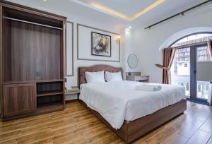 Postel nebo postele na pokoji v ubytování Win Hotel Đà Lạt + 37 fotografií