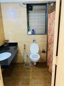 a bathroom with a toilet and a sink at Lake View Lavish studio in Lavasa