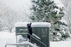 a person standing on a rail in the snow at MUWA NISEKO in Niseko