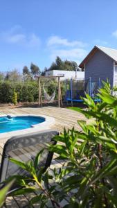 a backyard with a playground with a swing at Casa Charlotte in San José