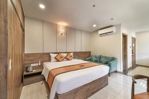 a bedroom with a large bed in a room at Bcons PS Hotel and Apartment- Newly Opened Hotel in Bien Hoa +41 photos