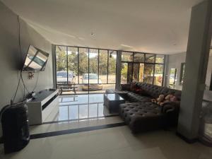 a living room with a couch and a large window at WildernessMountain View in Ban Thung Ta In +13 photos