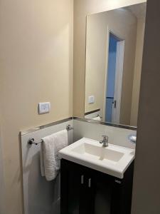 a bathroom with a sink and a mirror at Reserva Tajamar in Alta Gracia