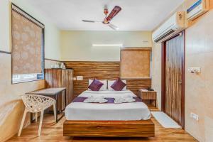 a bedroom with a bed and a chair in it at Season 4 Residences - Nungambakkam Near US consulate, Apollo Hospital, Shankar Nethralaya in Chennai