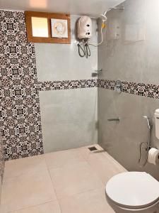 a bathroom with a toilet and a shower at Srivilas in Pudunagaram