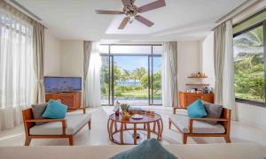 a living room with a couch and a table at Cam Ranh Riviera Beach Resort & Spa in Cam Ranh