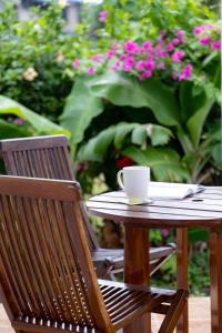a wooden table with a coffee cup on top of it at Croton House, Nadi in Nadi