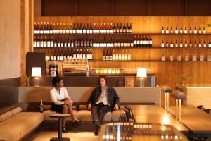 two people sitting on a couch in a restaurant at NOHGA HOTEL KIYOMIZU KYOTO in Kyoto