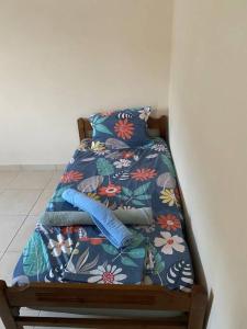 a bed with a comforter and pillows on it at Tzouliano’s Apartment in Sarandë
