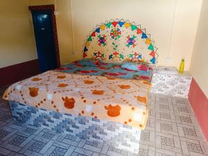a bedroom with a bed with a tiled floor at Rann Kutch Resort in Dhordo