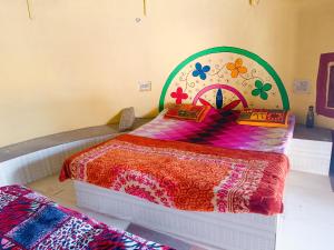 a bedroom with a bed with a colorful bedspread at Rann Kutch Resort in Dhordo