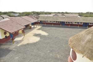 a group of buildings with roofs and a courtyard at Rann Kutch Resort in Dhordo