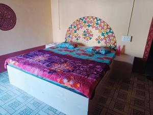 a bedroom with a bed with a colorful bedspread at Rann Kutch Resort in Dhordo