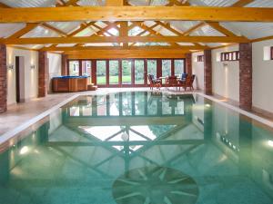 a swimming pool in a house with a ceiling at The Farmhouse - Uk45894 in Banham