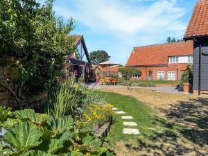 a garden in front of a house at The Farmhouse - Uk45894 in Banham