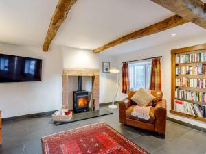 a living room with a chair and a fireplace at 3 Bed in Caldbeck 86087 in Caldbeck