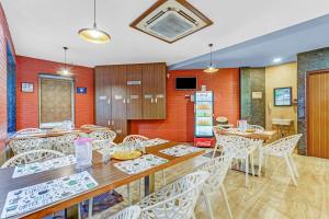a dining room with tables and white chairs at Season 4 Residences - Nungambakkam Near US consulate, Apollo Hospital, Shankar Nethralaya in Chennai