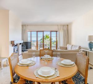 ein Wohnzimmer mit Tisch und Stühlen und einer Couch in der Unterkunft 26 Front row penthouse golf and sea views Manilva Duquesa Andalusia in Manilva