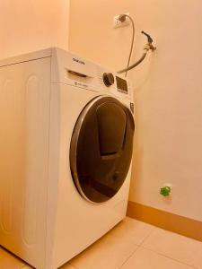 a washing machine in a corner of a room at Bayshore 2 Residences in Manila