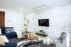 a living room with a couch and a tv on a wall at Nice 3 bedroom Apartment Space Available in Accra