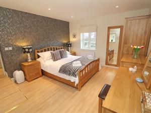 a bedroom with a bed and a table in it at 3 Bed in Nr Bamburgh CN035 in Belford