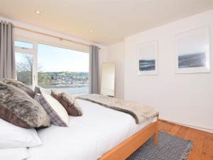 a bedroom with a bed and a large window at 4 Bed in Brixham 76402 in Brixham