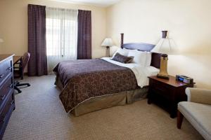 a hotel room with a bed and a television at Staybridge Suites Corpus Christi by IHG in Corpus Christi +39 photos