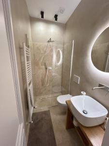 a bathroom with a shower and a sink and a toilet at Garibaldi14 in Chianciano Terme