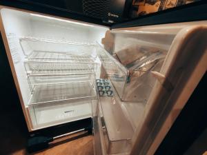 an empty refrigerator with its door open and itsartmentsearchacersacersacers at Daily BASIS 3-BEDROOMS FAMILY APARTMENT in Islamabad