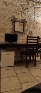 a table and two benches in a room with a wall at Black Rose in Bari +3 photos