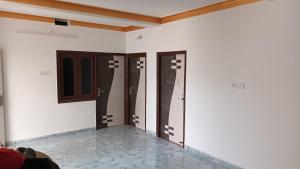a room with three doors on the wall at Sujata Buddha Homestay in Bodh Gaya +10 photos