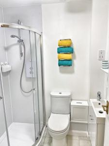 a bathroom with a shower and a toilet and towels at Ground floor Central 1 bed with parking in Aberdeen