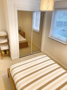 a bedroom with a bed and a mirror at Ground floor Central 1 bed with parking in Aberdeen