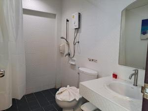 La salle de bains est pourvue de toilettes et d'un lavabo. dans l'établissement Baan Oui guest house - Nai harn, à Phuket
