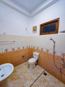 a bathroom with a toilet and a sink at Yoma Wild Hotel in Udawalawe