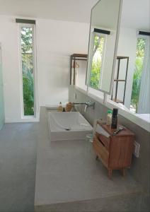 a bathroom with a white tub and a sink at KPG Suite Dream in Ban Nua