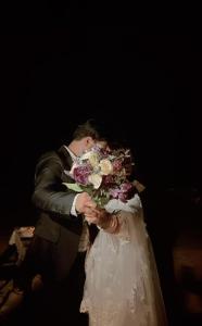 a man and a woman holding a bouquet of flowers at Rihiveli Inn in Veymandoo