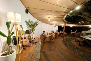 a group of people sitting at tables in a room at Batan Sabo & Co in Nusa Penida