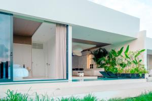 a modern house with a large glass window at GREEN FlOW Villas Ubud II in Ubud