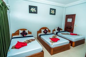 Postel nebo postele na pokoji v ubytování Golden Papaya Guesthouse